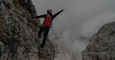 Mountain climber ascending a steep peak, representing business growth and the need for scalable multi-entity accounting software