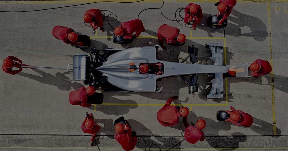 Racing team pit crew executing a fast, coordinated pit stop—symbolizing the precision, speed, and teamwork of a scalable Bill of Materials system for growing businesses.