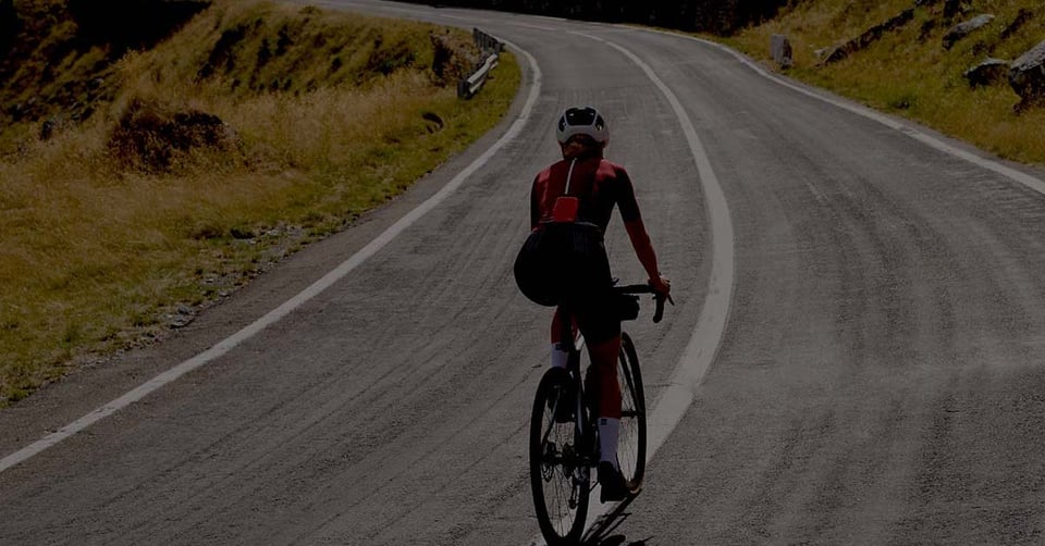 Cyclist riding toward the next stage of growth, representing businesses moving beyond QuickBooks Online to scalable accounting software.