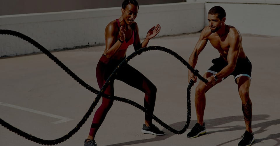 Athletes using battle ropes representing financial integration across healthcare private equity acquisitions