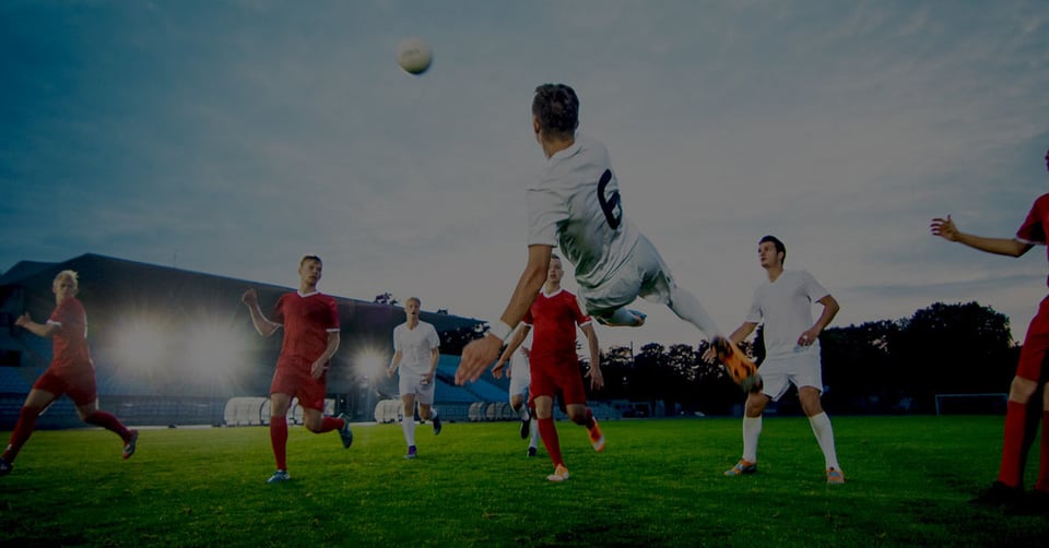 Soccer players working together during a match, representing coordinated management of multiple companies in one database
