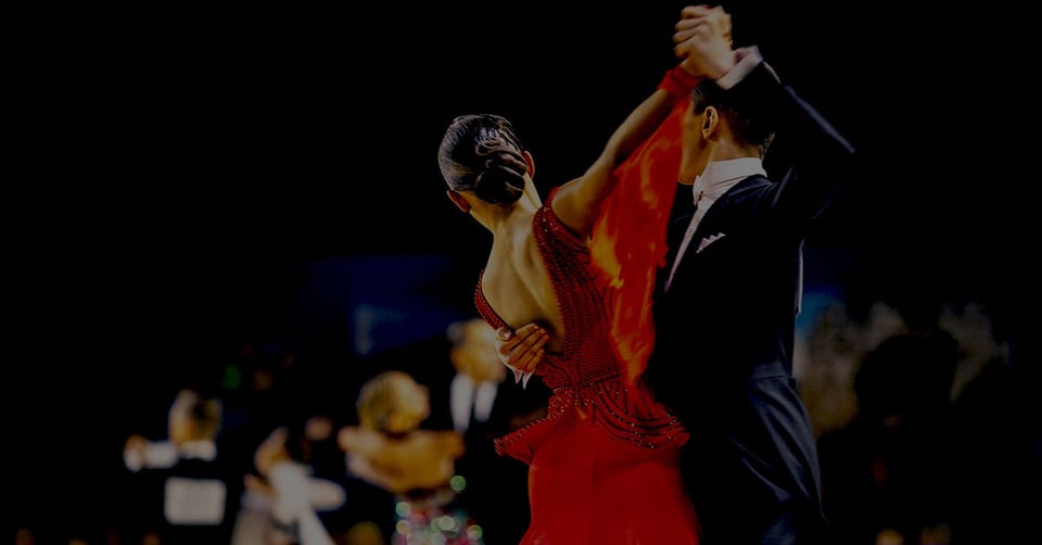 Competitive ballroom dancers representing coordination across multiple companies