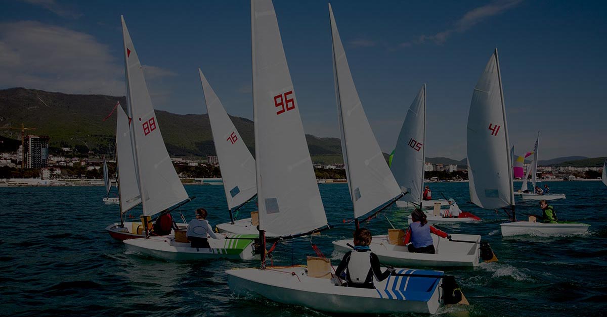 Separate sailboats representing disconnected accounting processes across multiple companies