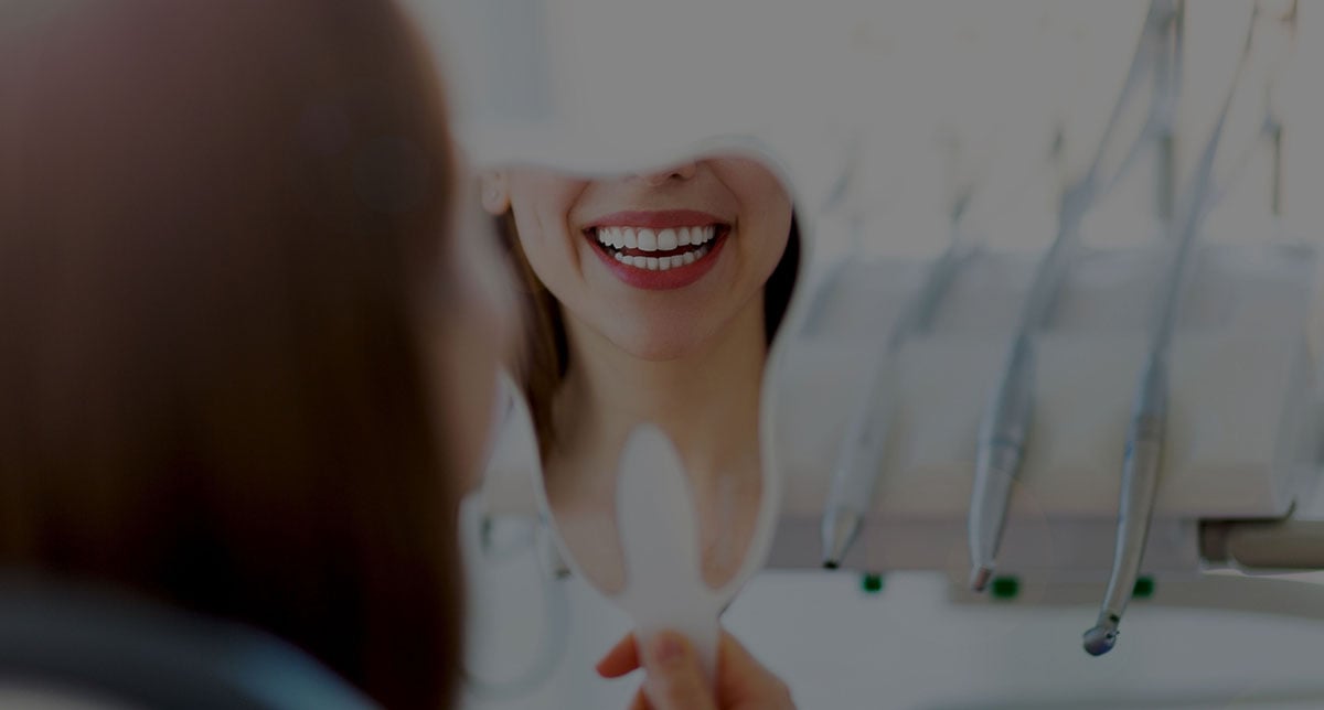 Patient smiling during a dental consultation representing a multi-location dental practice