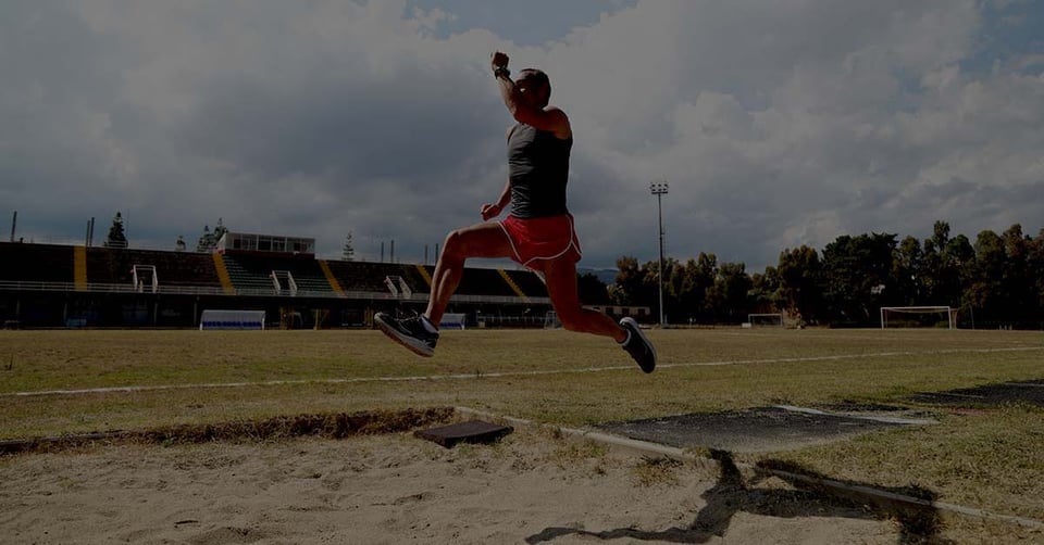 Athlete performing a long jump representing businesses making the leap from QuickBooks to multi-entity accounting software